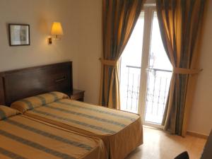 Postel nebo postele na pokoji v ubytování Hotel Tio Felipe