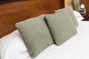 two pillows sitting on top of a bed at The Castle Inn Hotel by BW Signature Collection, Keswick in Keswick