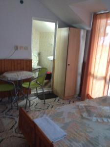 a room with a table and chairs and a room with a door at Central Guesthouse in Nesebar