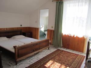 a bedroom with a bed and a window and a rug at Central Guesthouse in Nesebar +12 photos