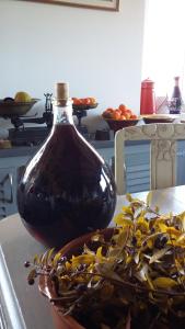 a bottle of oil sitting on a table next to a plant at Corsica Monti Gite Appart in Petreto-Bicchisano