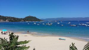 a beach with a bunch of boats in the water at Corsica Monti Gite Appart in Petreto-Bicchisano