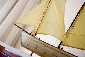 a wooden sail boat on display in a room at Relais Blu in Massa Lubrense