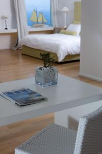 a bedroom with a table with a book and a bed at Relais Blu in Massa Lubrense