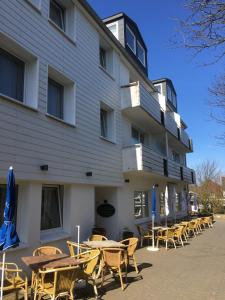 a row of tables and chairs in front of a building at Hotel Mocca-Stuben in Helgoland