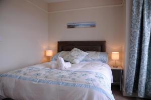 a bedroom with a large bed with two lamps at Eask View Dingle - Room Only in Dingle