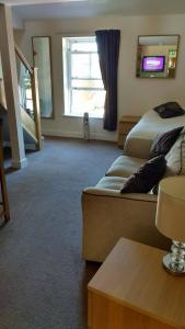 a hotel room with two beds and a window at The Anchor Ely in Ely