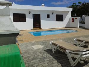 a house with a swimming pool in front of it at Vivienda vacacional Finca Ribera De Cortes in Nazaret