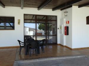 a dining room with a table and chairs at Vivienda vacacional Finca Ribera De Cortes in Nazaret