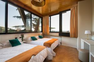 Voodi või voodid majutusasutuse Grand Hotel Panoramic toas