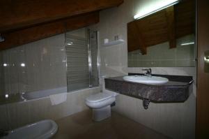 a bathroom with a sink and a toilet at Hotel Can Mestre in El Pont de Suert
