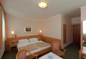 Postel nebo postele na pokoji v ubytování Hotel Hallerhof