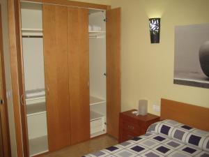 1 dormitorio con cama y armario de madera en Apartamento Santa Cruz de Tenerife, en Santa Cruz de Tenerife