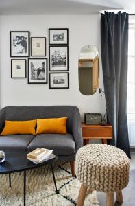 a living room with a couch and a tv at My Maison In Paris - Sentier in Paris