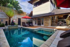 a swimming pool in the backyard of a house at La Bella Vita Residence in Seminyak