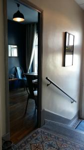a door that is open to a room with a mirror at Hotel Napoléon in Cherbourg en Cotentin