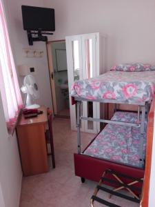 Postel nebo postele na pokoji v ubytování Hotel Parigi