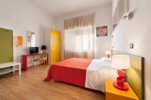 a bedroom with a bed and a table with a lamp at Lucca in Villa San Marco in Lucca