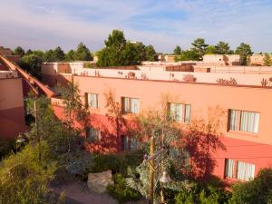 un edificio de naranjos con árboles delante de él en Disney Hotel Santa Fe, en Coupvray