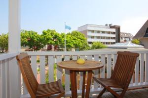 a table and two chairs on a balcony at Villa Gudrun in Westerland
