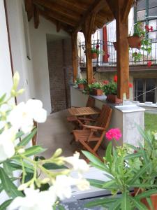 a patio with chairs and flowers on a building at Hotel Diána in Pécs