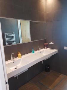 a bathroom with two sinks and a large mirror at Eden Island Villa - Bouznika in Bouznika