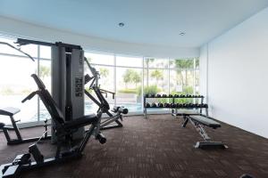 a gym with treadmills and machines in a room at Palm Armada Residence Free Parking and Netflix in Putrajaya
