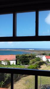 a view of the ocean from a window at Casa da Lagoa AL 416 in Fajã da Caldeira de Santo Cristo