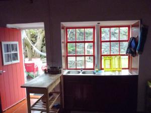a kitchen with a sink and a window at Casa da Lagoa AL 416 in Fajã da Caldeira de Santo Cristo