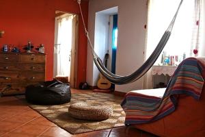 a room with a hammock in a room at Casa da Lagoa AL 416 in Fajã da Caldeira de Santo Cristo