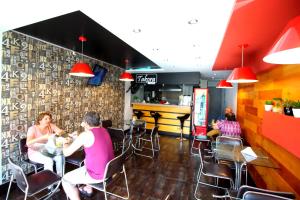 a group of people sitting at a table in a restaurant at Takora Inn in Tacna