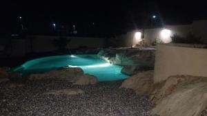 a swimming pool in a yard at night at Terra Rossa in Loborika