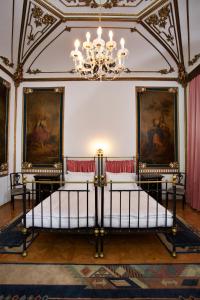 a bedroom with a bed in a room with paintings at Hotel Wandl in Vienna