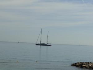 a sailboat sitting on the water in the ocean at Appartement La Tourraque côté mer in Antibes