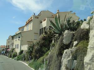 a building on the side of a rocky hill at Appartement La Tourraque côté mer in Antibes