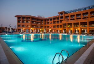 a large swimming pool in front of a building at Cancun Sokhna Resort & Villas in Ain Sokhna