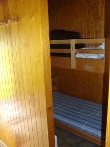 a room with two bunk beds in a cabin at Le Champbourguet in Super Besse