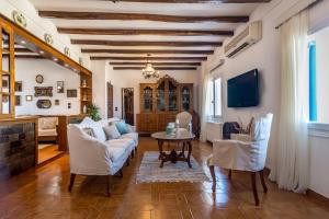 a living room with a couch and a table at Traditional House Milos in Pollonia