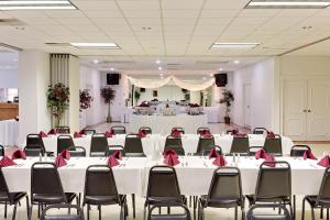 a banquet hall with white tables and chairs and a ballroom at Ramada by Wyndham Richland Center in Richland Center +36 photos