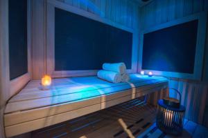 a room with a bench with lights and a candle at Atlantic Hôtel & Spa in Les Sables-d'Olonne