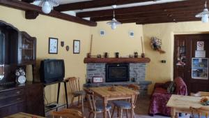 a living room with a table and a fireplace at Affitta Camere La Dolce Sosta in Perosa Argentina