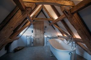 a bathroom with a white tub and a sink at Le B. VINTAGE in Riquewihr