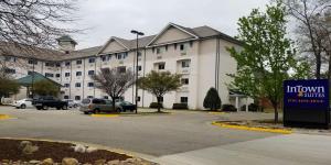 a large white building with a sign in front of it at InTown Suites Extended Stay Newport News VA - I-64 in Newport News