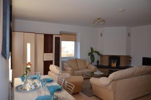 a living room with a couch and chairs and a table at Apartments with spa Jacuzzi and sauna in Vilnius