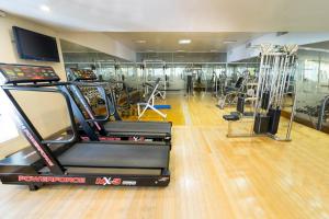 a gym with several treadmills and machines in it at Claridge Hotel in Buenos Aires