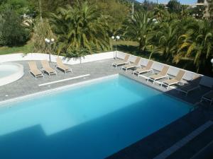 a swimming pool with lounge chairs and a swimming pool at Beautiful holiday home near Moriani Plage in San-Nicolao