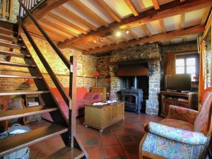 a living room with a staircase and a fireplace at Attractive Cottage in Baillamont with Terrace in Bièvre