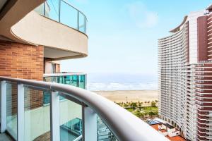 a view of the ocean from the balcony of a building at Residencial Estanconfor Santos in Santos