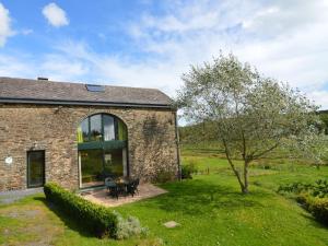 a stone house with a window and a table at Comfortable Cottage in Neufmoulin with Meadow View in Houffalize