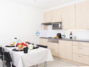 una cocina con una mesa con un plato de comida. en Stylish Apartment in Bredene with Pool, en Bredene
